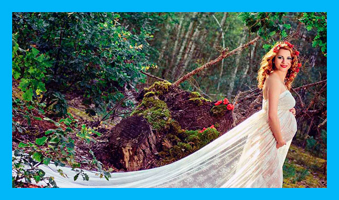 красивая фотография беременной женщины в белом длинном платье в лесу